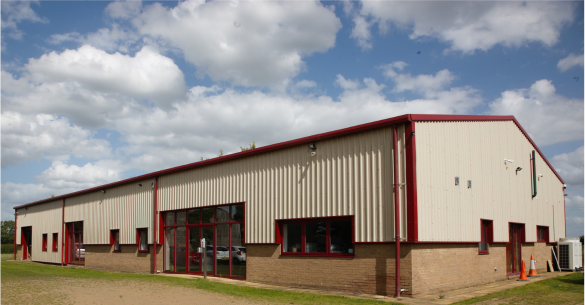 Office building with a red roof against a blue sky